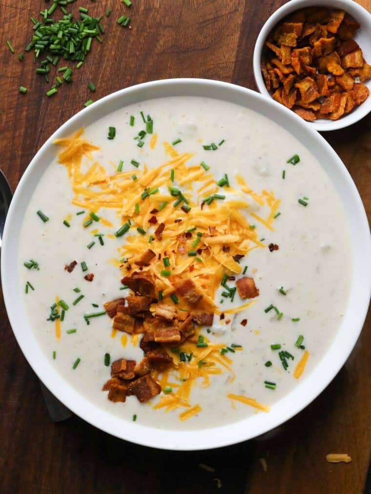 loaded baked potato soup with bacon, cheddar and chives in a bowl