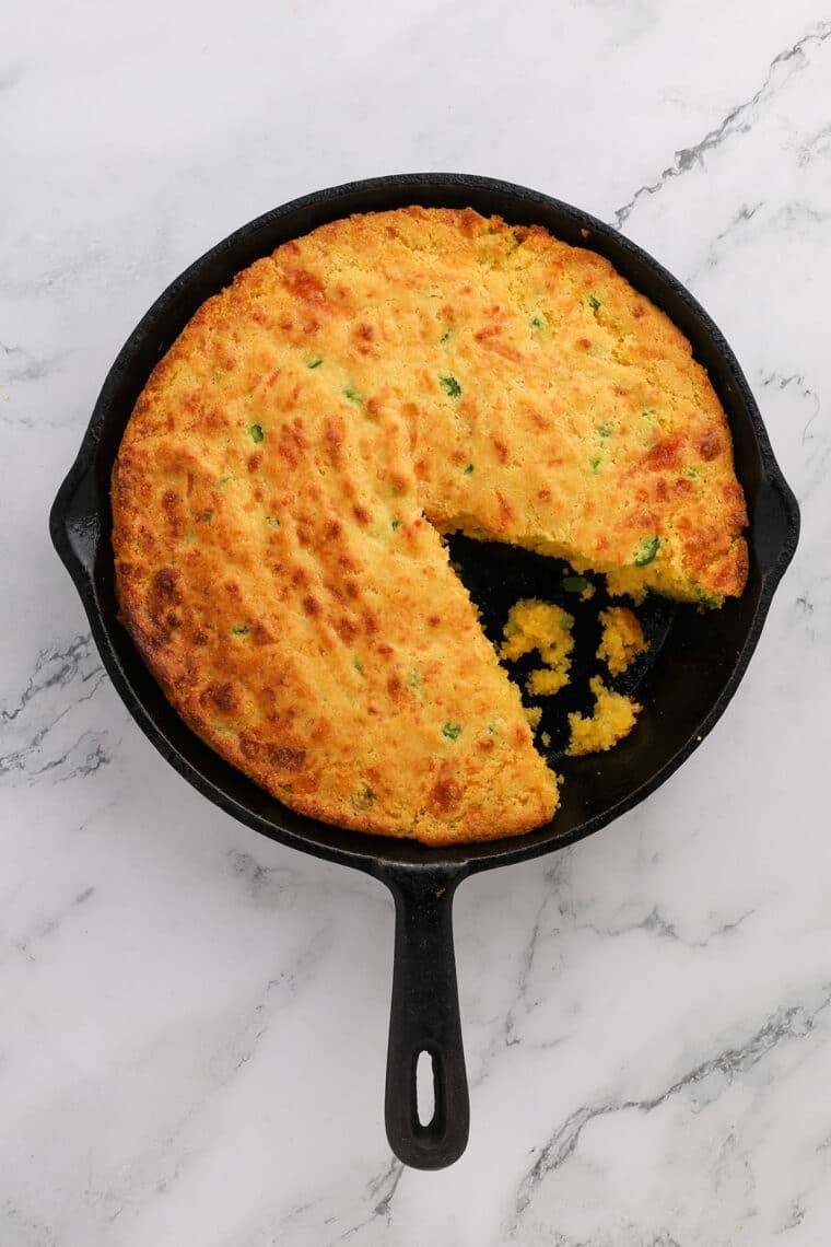 top down view of jalapeno cheddar cornbread in a cast iron skillet