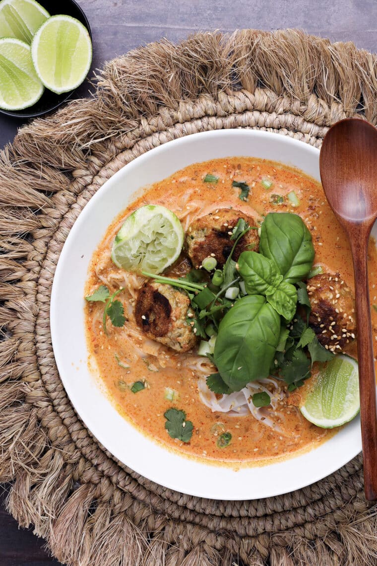 Bowl of Creamy Ginger Chicken Meatball Soup with noodles and cilantro