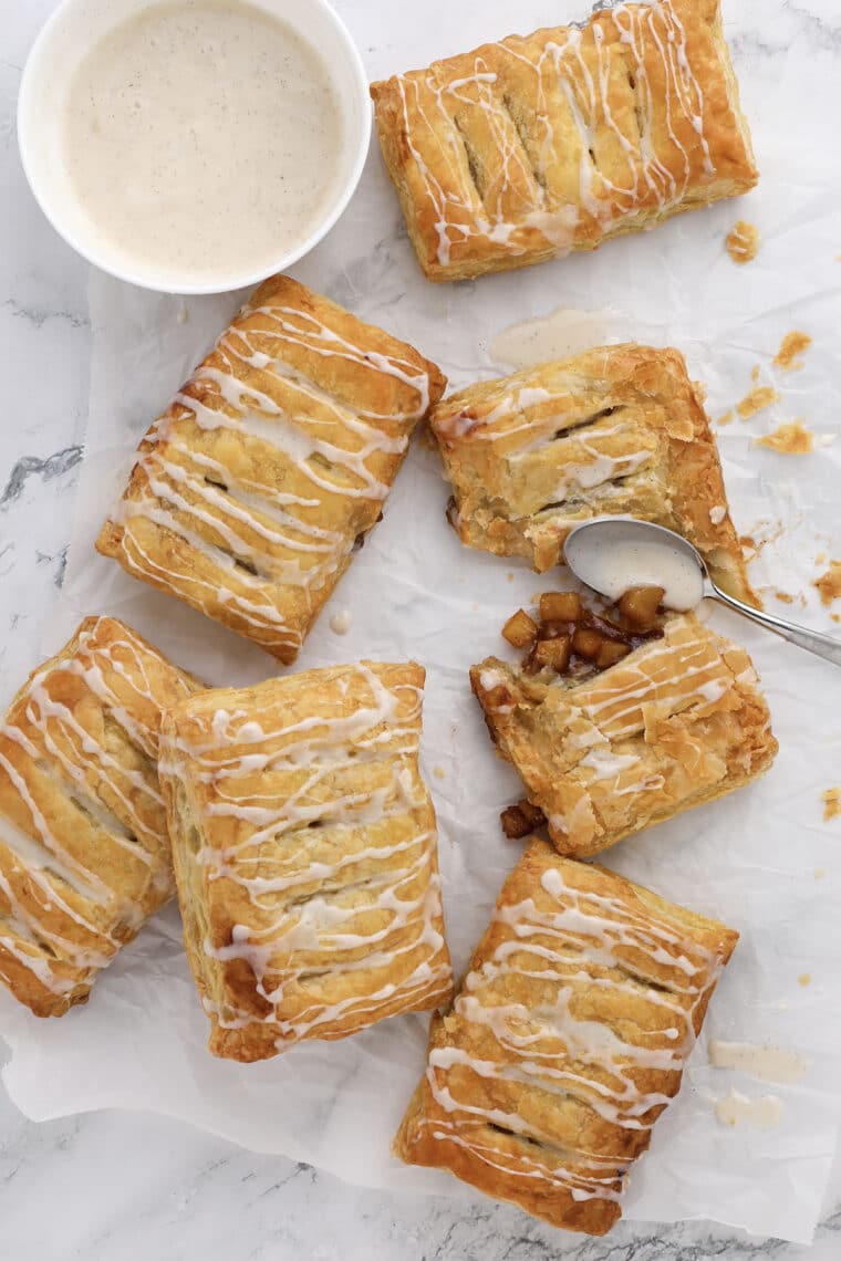 pumpkin apple turnovers with vanilla glaze on a marble background